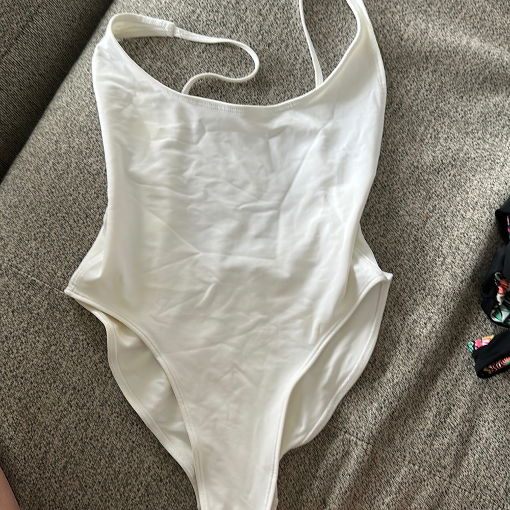 Fashionova white one piece with low back and side boob.